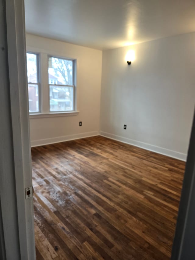 empty room with dark wood-type flooring