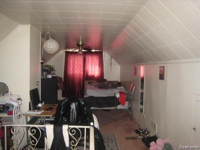 carpeted bedroom featuring lofted ceiling