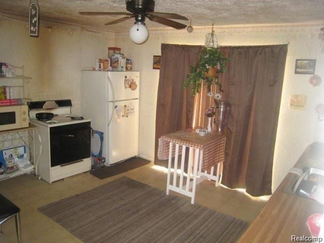 kitchen with white appliances and ceiling fan