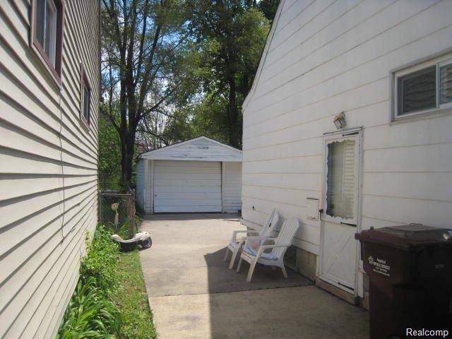 view of patio / terrace with a garage and an outdoor structure