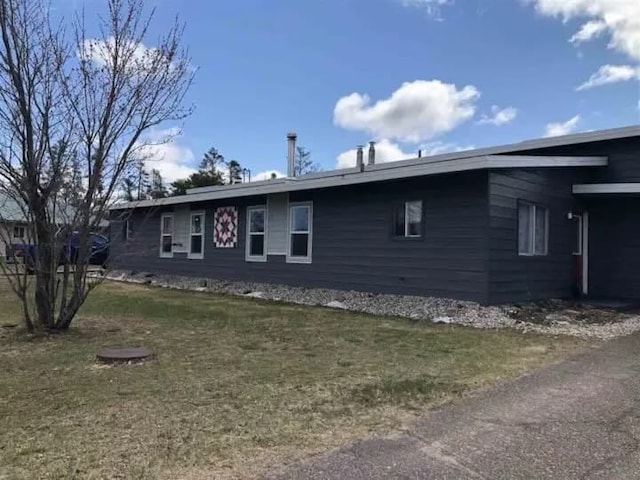 view of side of property with a lawn