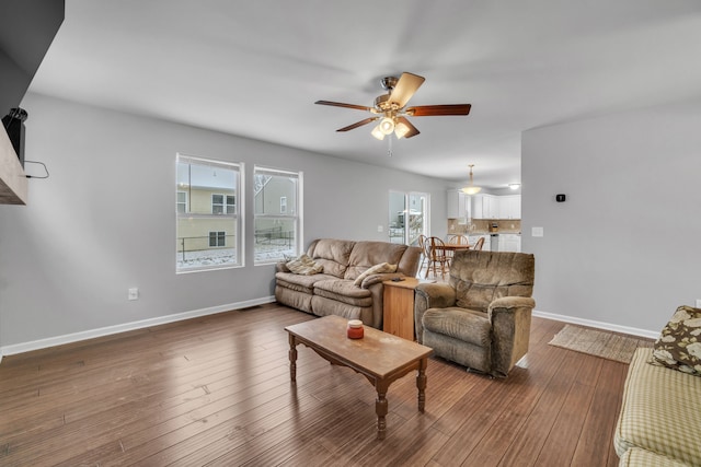 living room with wood-type flooring and ceiling fan