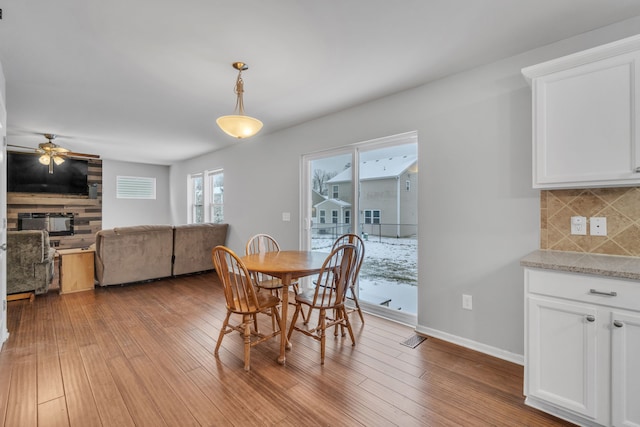 dining area featuring ceiling fan and light wood-type flooring