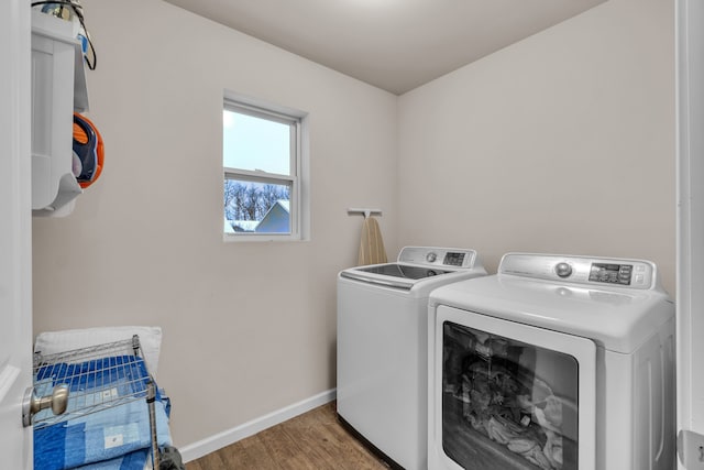 laundry area featuring wood-type flooring and separate washer and dryer