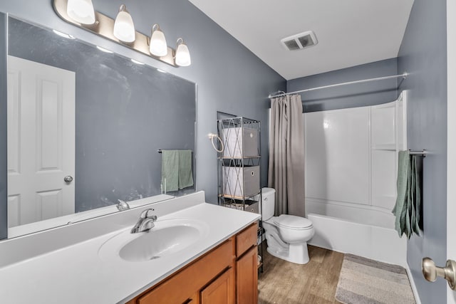 full bathroom with vanity, hardwood / wood-style flooring, toilet, and shower / bath combo with shower curtain