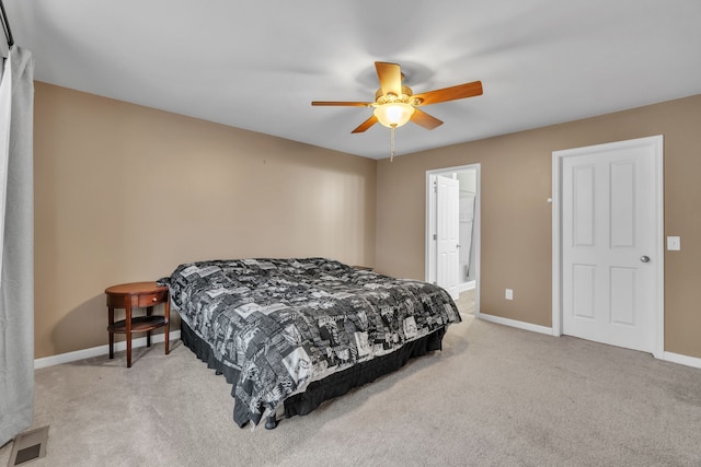 carpeted bedroom with ceiling fan and ensuite bathroom