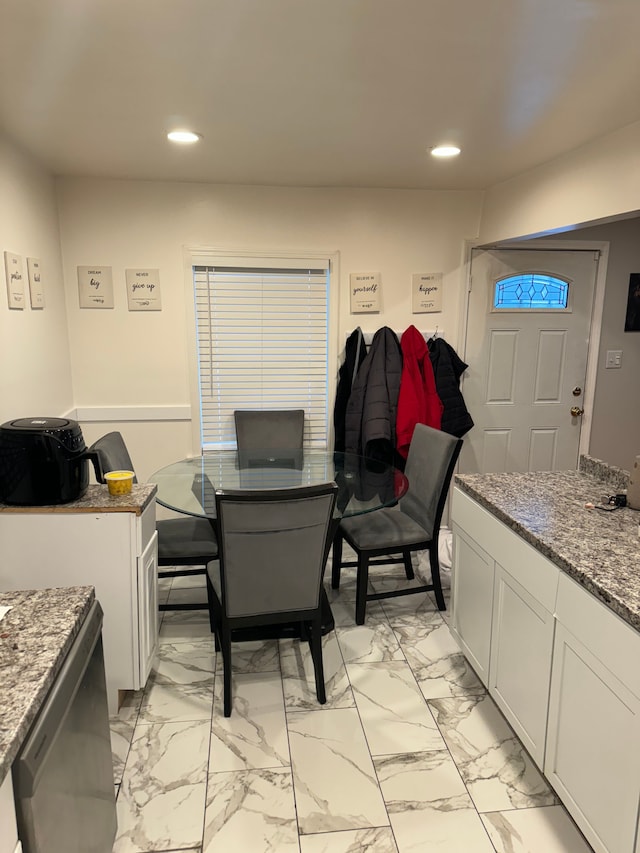 interior space featuring white cabinets and dark stone counters