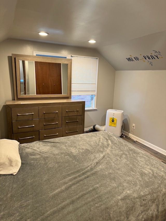 bedroom featuring dark hardwood / wood-style floors and lofted ceiling