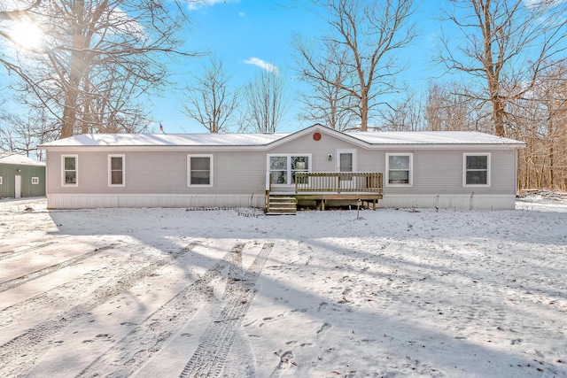 snow covered property featuring a deck