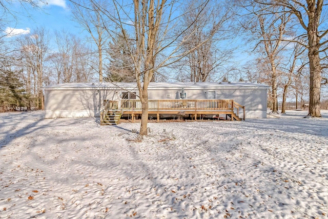 snow covered property featuring a deck