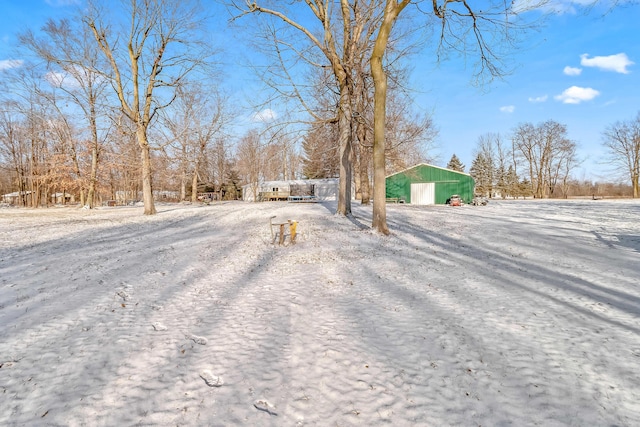 yard layered in snow featuring an outbuilding