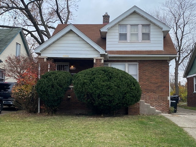 bungalow-style home featuring brick siding, a chimney, and a front lawn