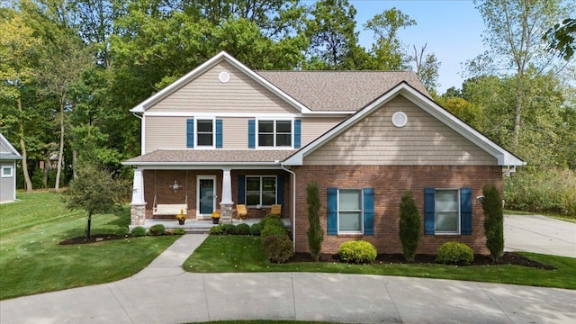 view of front of house with covered porch and a front lawn