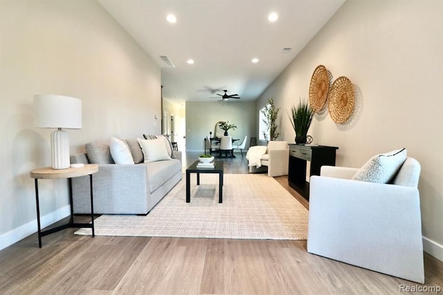 living room with ceiling fan and hardwood / wood-style floors