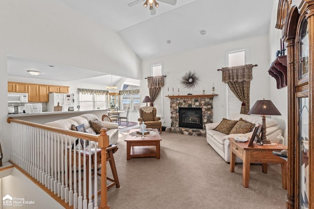 living room with a fireplace, light colored carpet, ceiling fan, and lofted ceiling