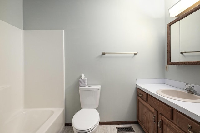 full bathroom with vanity, toilet, and  shower combination