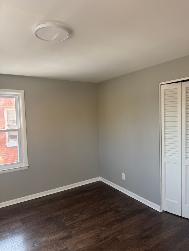 empty room with dark wood-type flooring