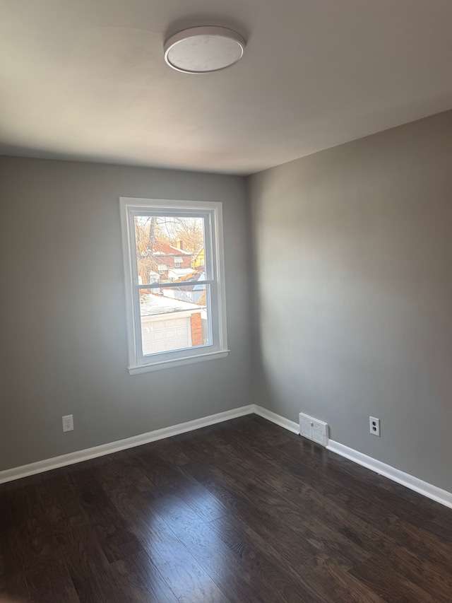 empty room with dark hardwood / wood-style floors