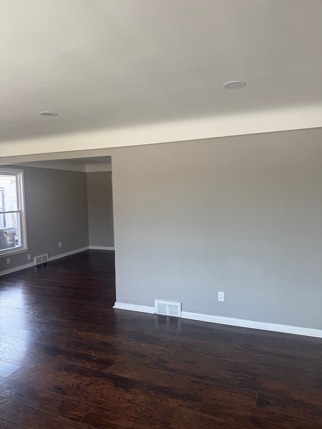 unfurnished room featuring dark hardwood / wood-style floors