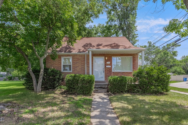 bungalow-style house featuring a front yard