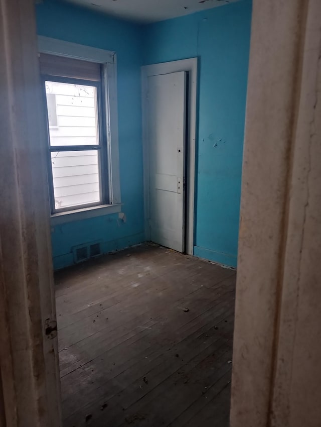 spare room with hardwood / wood-style floors