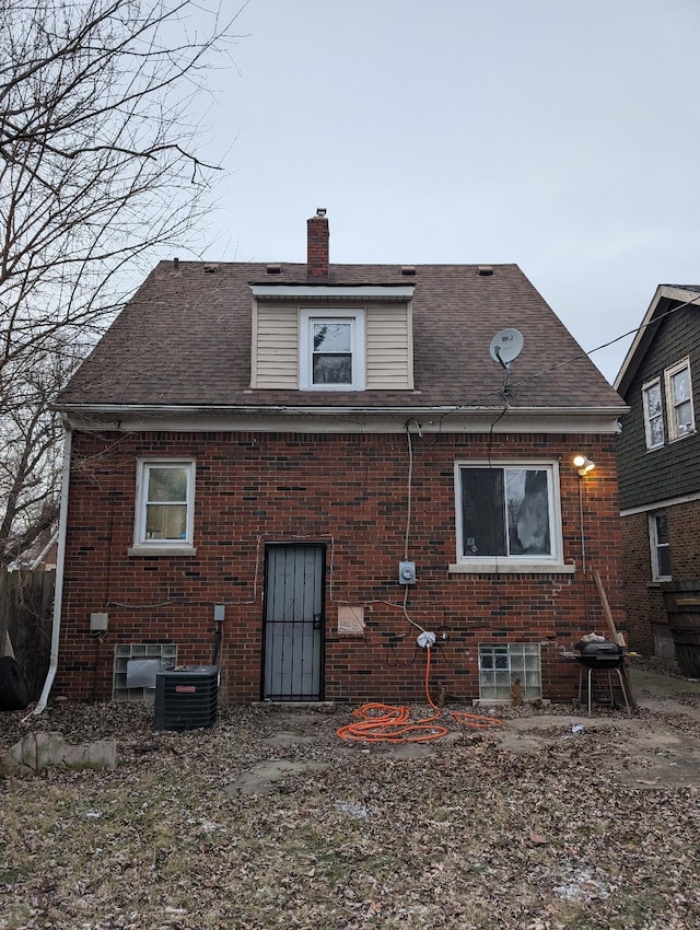 rear view of house with central AC unit