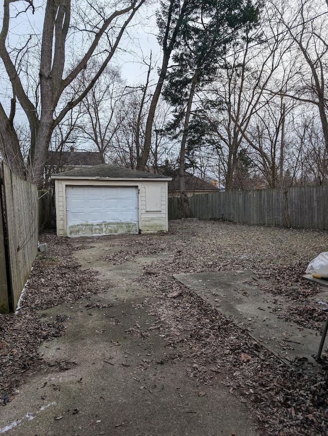 view of yard with a garage and an outbuilding