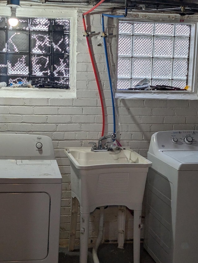 clothes washing area with washer and dryer