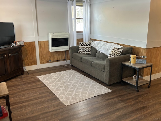 living room featuring heating unit and dark hardwood / wood-style flooring