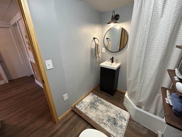 bathroom featuring hardwood / wood-style floors, vanity, and curtained shower