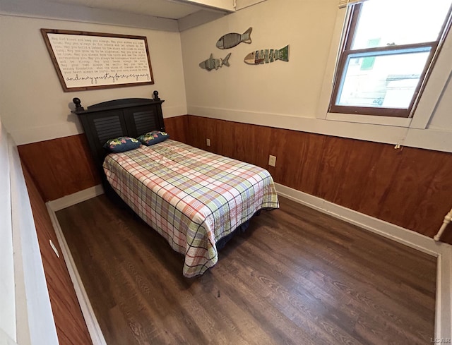 bedroom with dark hardwood / wood-style flooring