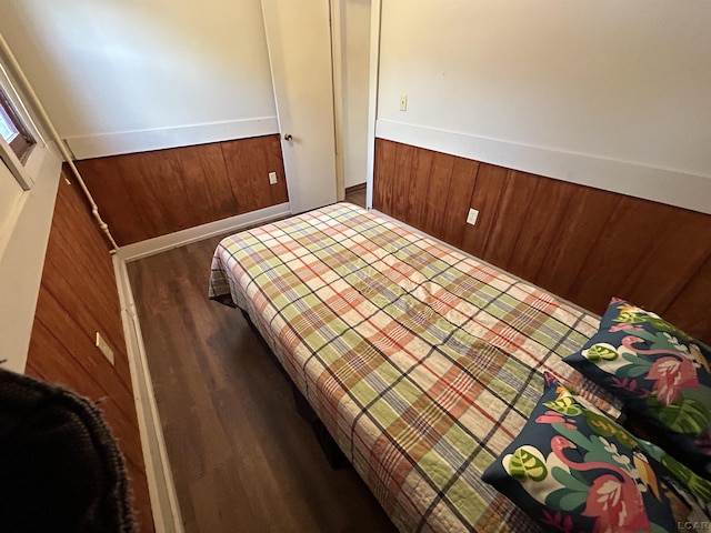 bedroom with dark hardwood / wood-style flooring