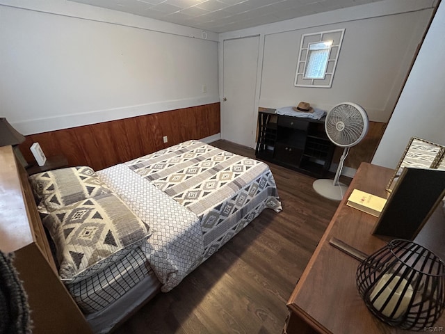 bedroom with dark hardwood / wood-style floors