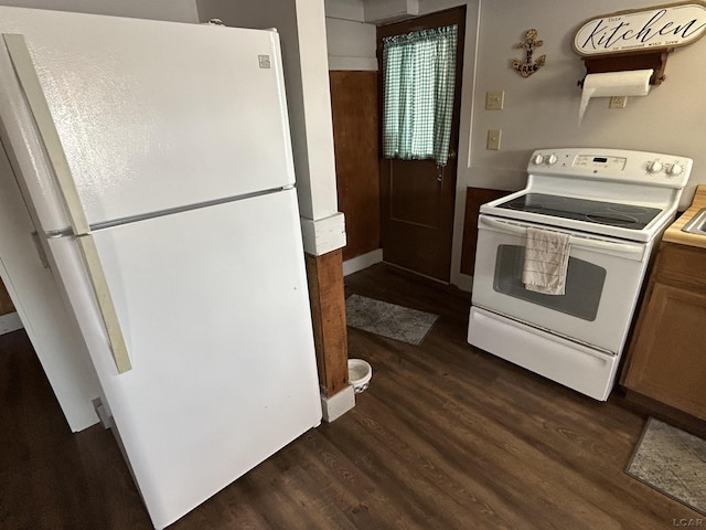 kitchen featuring dark hardwood / wood-style flooring and white appliances