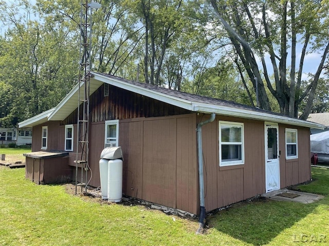 view of outbuilding featuring a lawn