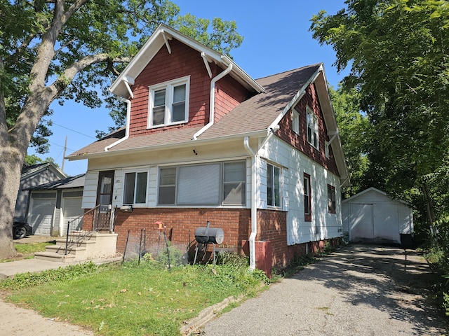 view of front of home with a shed