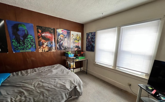 bedroom with a textured ceiling and wood walls