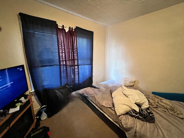 carpeted bedroom featuring a textured ceiling