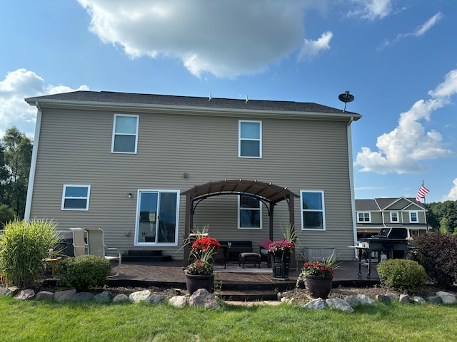 rear view of property with a lawn, a patio area, a pergola, and a wooden deck