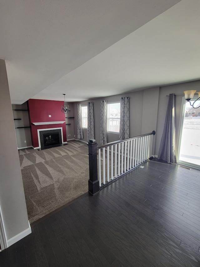 unfurnished living room with dark hardwood / wood-style flooring