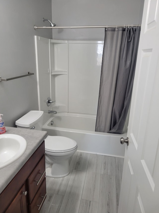 full bathroom featuring toilet, shower / tub combo, and vanity