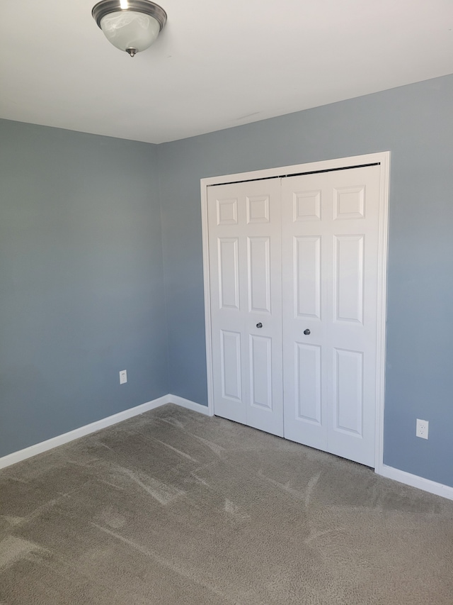 unfurnished bedroom featuring a closet and carpet