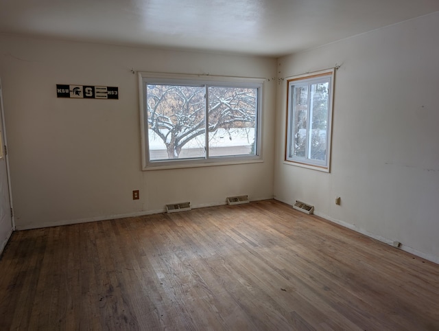 spare room featuring hardwood / wood-style flooring