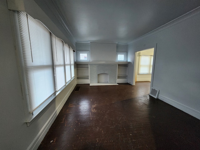 unfurnished living room featuring ornamental molding and a brick fireplace