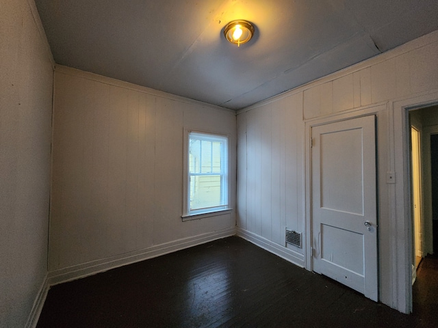 spare room with dark hardwood / wood-style flooring