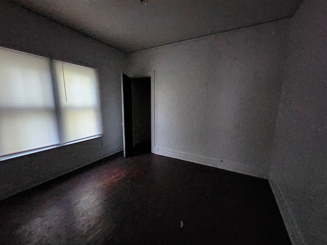 unfurnished room with hardwood / wood-style flooring