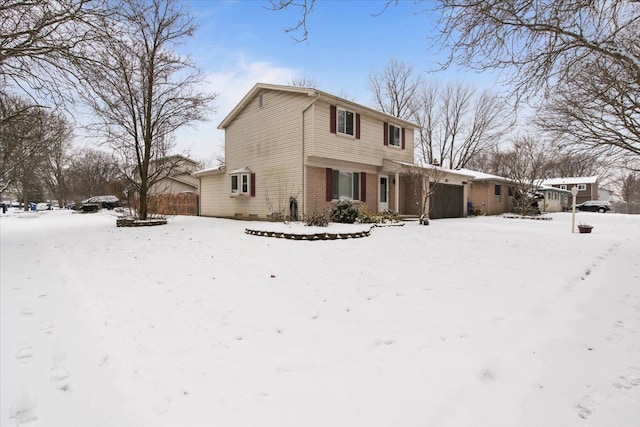 view of snow covered back of property