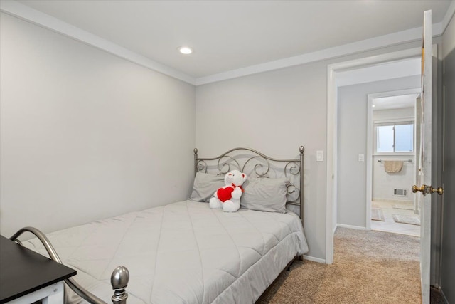 bedroom with crown molding and carpet floors