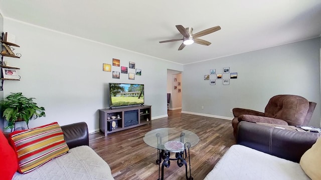 living room featuring ceiling fan and dark wood-type flooring