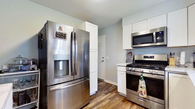 kitchen featuring white cabinetry, light hardwood / wood-style flooring, and stainless steel appliances